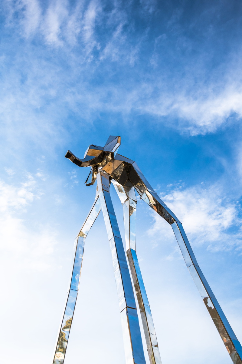 rust, pole, amusement park, turbine, sunlight, built structure, occupation, low angle view, outdoors, sky, building, industrial equipment, architecture