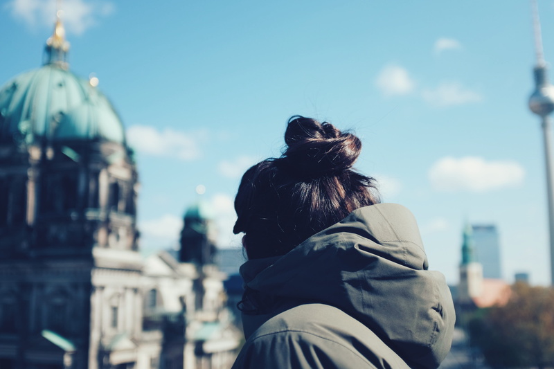travel destinations, adult, tv tower, berlin, museum, focus on foreground, rear view, sun, built structure, hairstyle, religion, leisure activity, sky