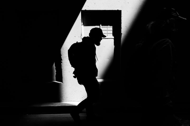 leisure activity, lifestyles, architecture, indoors, black Color, side view, real people, day, street, adult, window, built structure, focus on Shadow