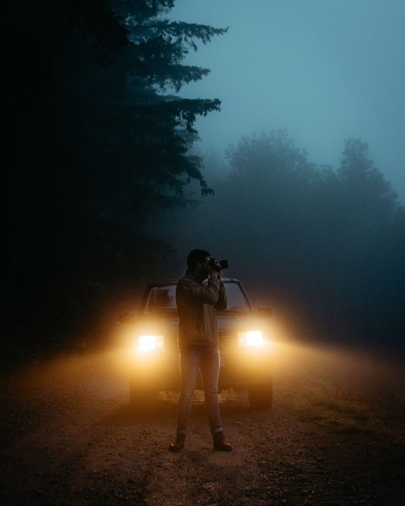 guy, land, nature, leisure activity, real people, person, mist, headlamps, trees, foggy, modern, headlight, tree, headlights, dirt road, male, taking photo