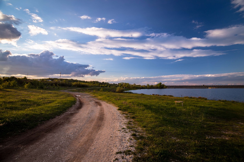 road, tranquil scene, beauty in nature, direction, landscape, water, field, countryside, dirt road, the way forward, rural, grass, non-urban scene, tranquility