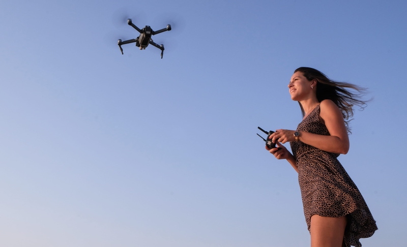 young women, sky, clear sky, mode of transportation, travel, aviate, wireless technology, person, controller, motion, air vehicle, wind, women, action