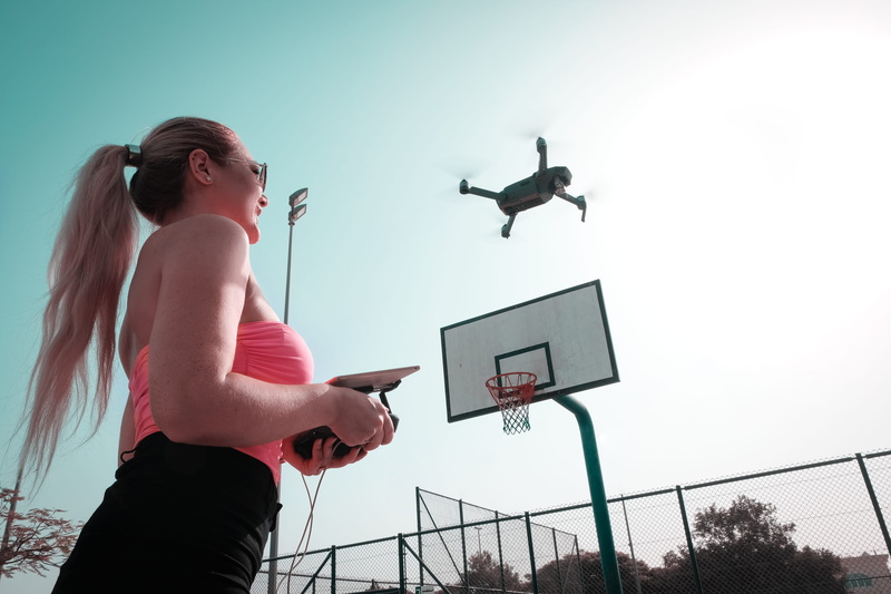 person, recreation, holding, hairstyle, controlling, fun, leisure, lifestyles, adult, enjoyment, basketball - sport, drone cam, court, day, women, motion