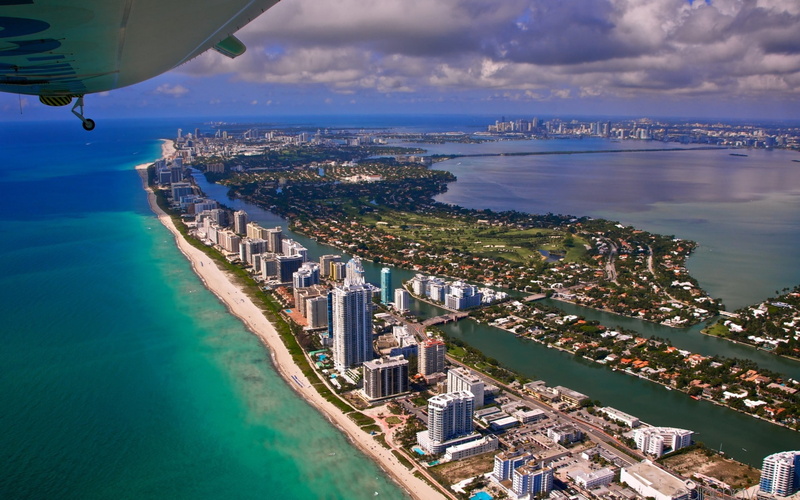 flight, architecture, 1080P, building exterior, cityscape, bay, transportation, beach, land, city, outdoors,  view from the height of, nature, sky, aerial view