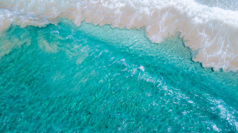 aquatic sport, rock, sea waves, scenery, outdoors, high angle view, beauty in nature, sport, landscape, surfing, wave, turquoise colored, tranquil scene