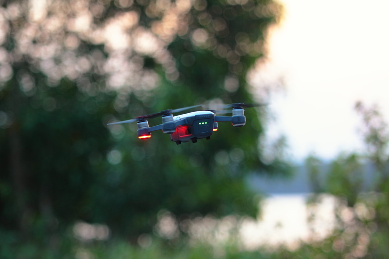mid-air, mode of transportation, dji, transportation, mavic, blur, red, 4K, outdoors, no people, bokeh, park, trees, plant, daylight, wireless technology