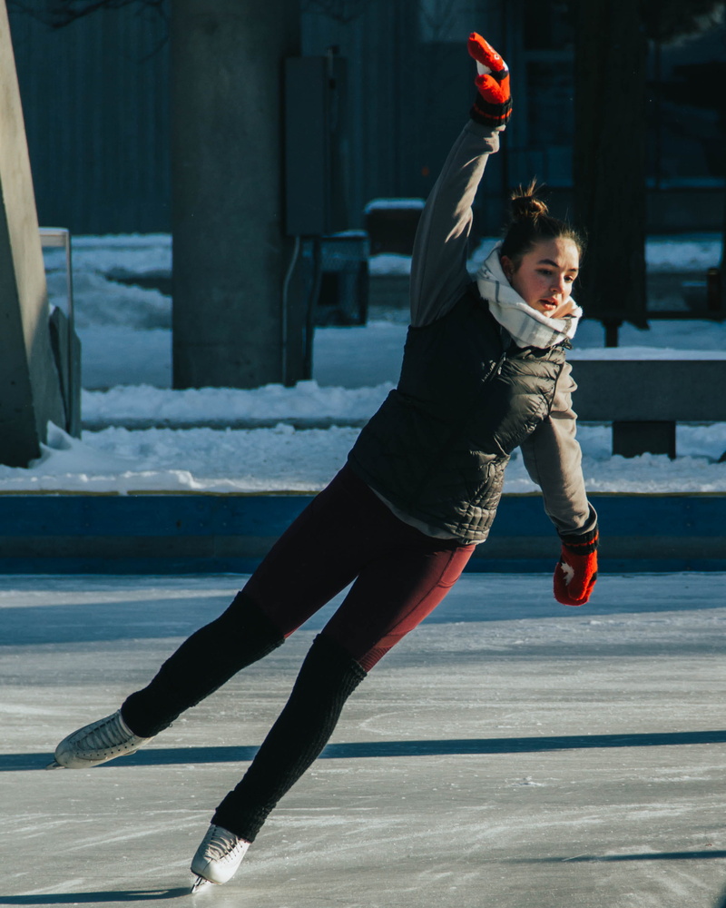 ice skating, apparel, sunlight, leisure activity, child, tennis, arms raised, shoe, person, cake, innocence, dance pose, winter, ice hockey, footwear, team sport