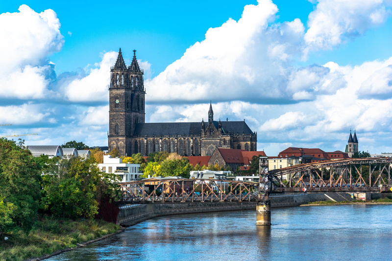 church, tower, architecture, city view, river, travel destinations, shore stone, bridge, tourism, homes, no people, spire, building exterior, bridge - man made structure