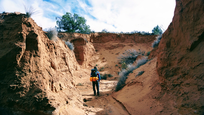 activity, canyon, sand, backpacker, hiker, beauty in nature, 5K, rock, riverbed, sky, day, rear view, travel, adventure, nature, people, outdoors, mountain