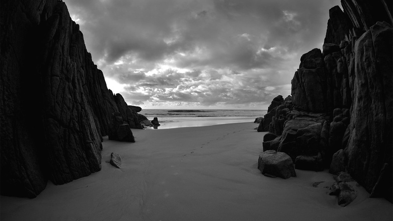 tranquil scene, monochrome, sea, no people, landscape, beauty in nature, water, rocky, formation, scenics - nature, sand, clouds, horizon over water, rock - object