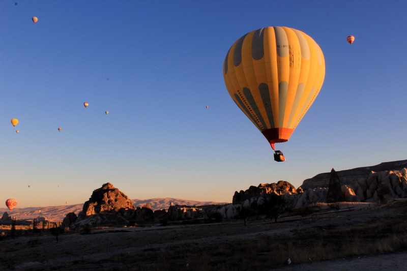 hot air balloon, adventure, rock - object, flying, sky, balloon, outdoors, solid, rock, air vehicle, ballooning festival, nevşehir, landscape, scenics - nature
