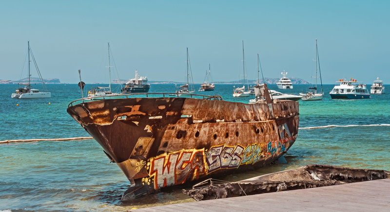 mast, sunlight, pier, beach, fishing industry, sand, no people, anchored, old, sailboat, broken, nautical vessel, landscape, sky, moored, transportation