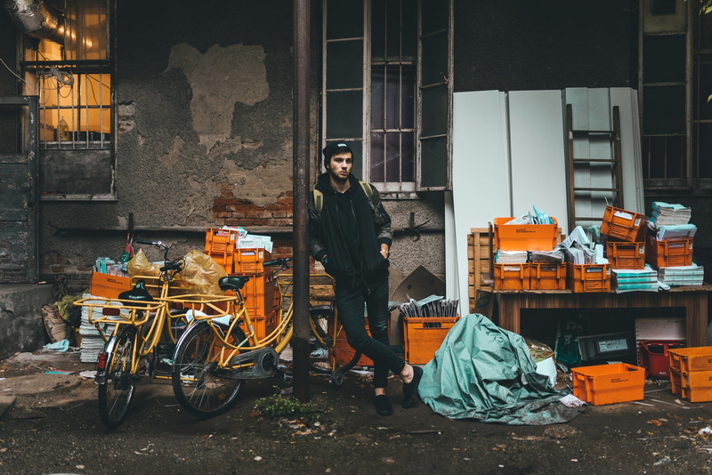 hat, jacket, model, garbage, standing, built structure, jeans, city, building exterior, concrete, pants, toque, alley, full length, guy, men, lifestyles