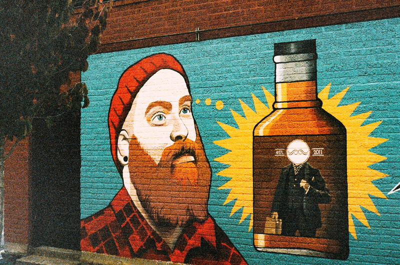 representation, plaid, man, hipster, wall - building feature, creativity, wood - material, no people, male likeness, whiskey, hat, human representation