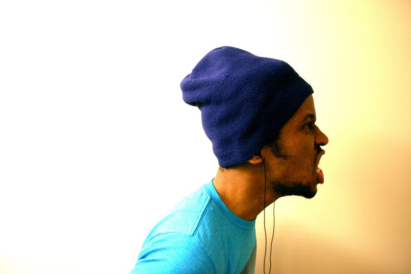 hat, wearing, blue, casual clothing, young men, men, clothing, young adult, toque, beard, earbuds, facial hair, people, contemplation, guy, indoors, side view