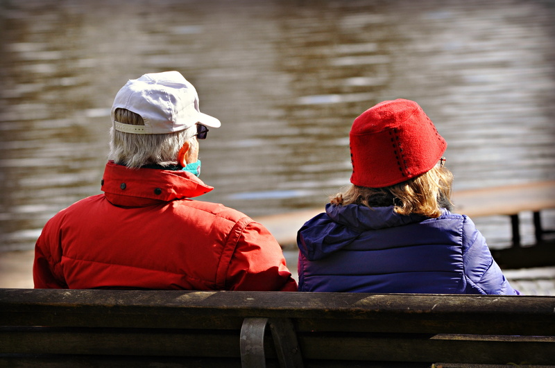 red, two people, 4K, focus on foreground, woman, men, cold temperature, bench, elderly, women, real people, man, rear view, couple, warm clothing, water