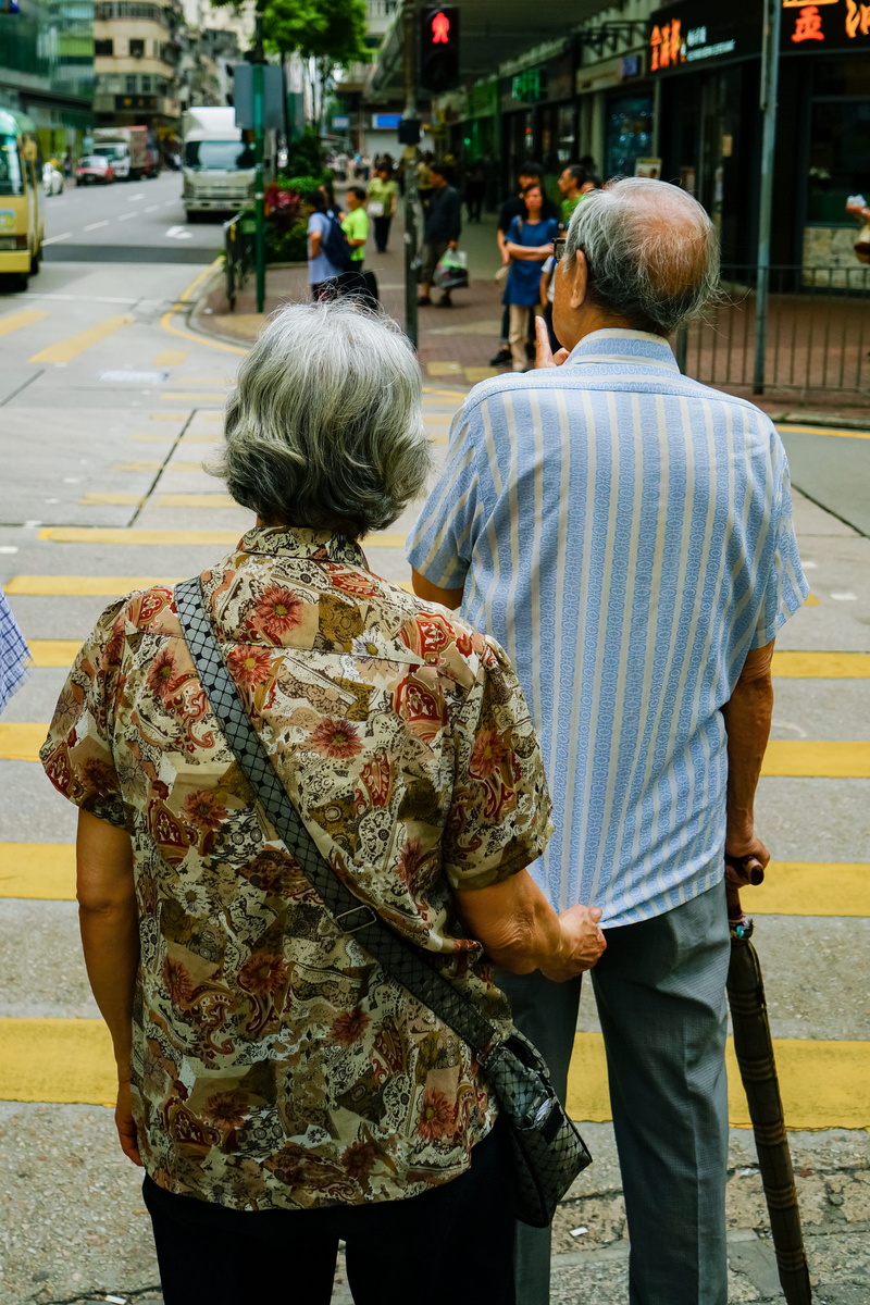 beside, adult, crosswalk, lifestyles, day, zebra crossing, pedestrian, men, couple - relationship, city, real people, elderly, daylight, street, togetherness