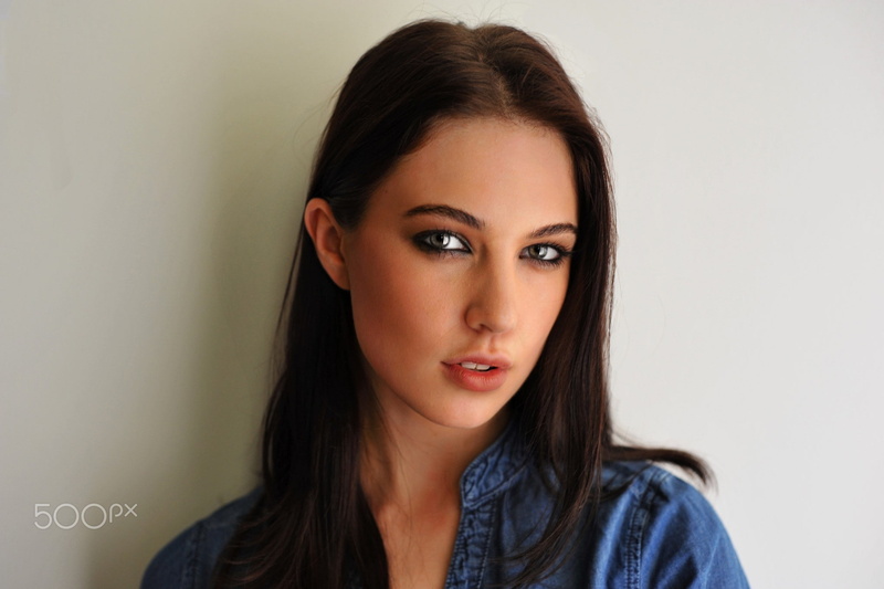 model, portrait, looking at camera, studio shot, brown hair, open mouth, looking at viewer, human face, hairstyle, beautiful woman, face, indoors, casual clothing