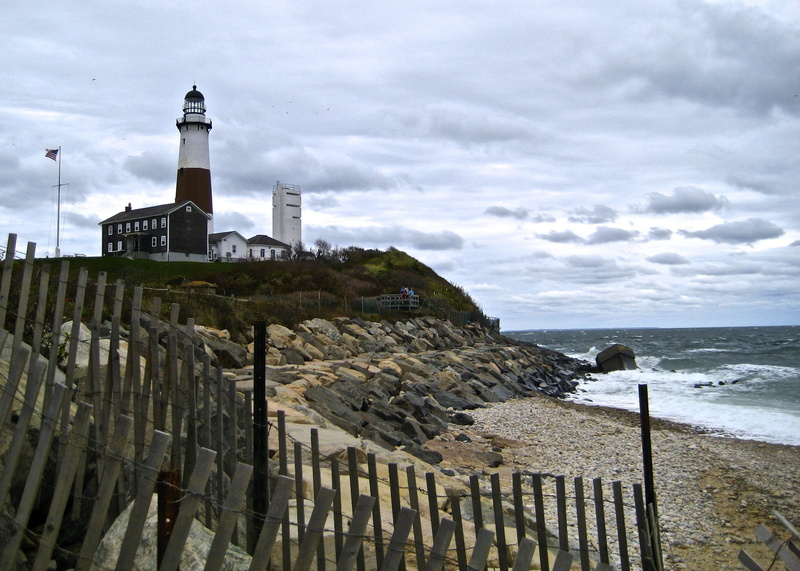 beach, island, coastline, built structure, Montauk Light, fence, sea, cliffs, landmark, tower, no people, Lighthouse, day, cloud - sky, peaceful, barrier