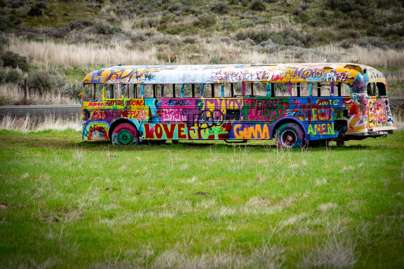 background, lacrosse, outdoors, bus, palouse falls road, united states, graffiti, motion, public transportation, decorate, land vehicle, field, tag, mode of transportation