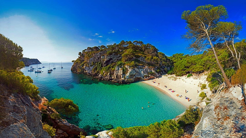 beach, beauty in nature, bay, menorca, solid, sea, rock - object, blue, water, theme, green, tree, plant, tranquility, travel destinations, body, turquoise colored