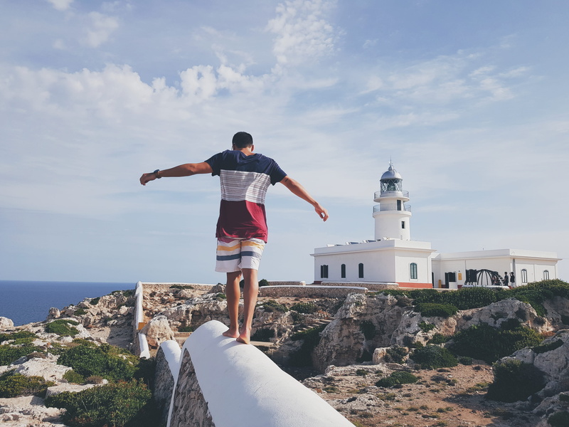 real people, sea, colour, building exterior, one person, summer, wearing, solid, architecture, white, nature, blue, sky, human arm, standing, rock - object