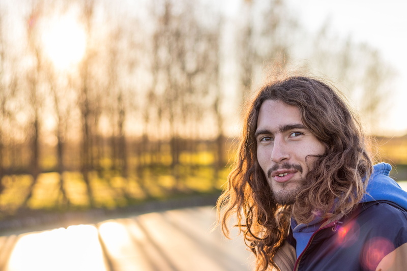 young adult, photo, apparel, brown hair, looking at camera, long hair, emotion, hairstyle, face, #man, outdoors, one person, photography, adult, smiling