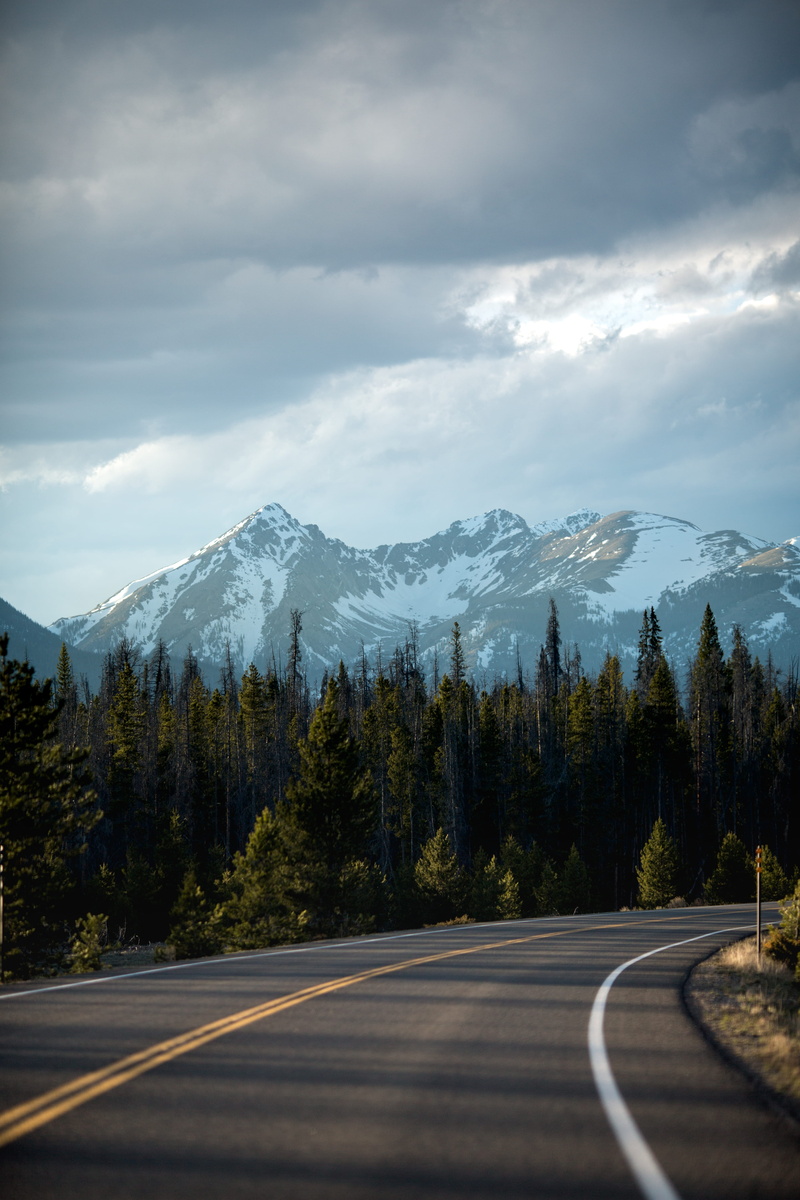 concrete road, rocky Mountains, green, green pine, mountain Range, marking, no People, transportation, outdoors, snowcapped mountain, long, travel, beauty in nature