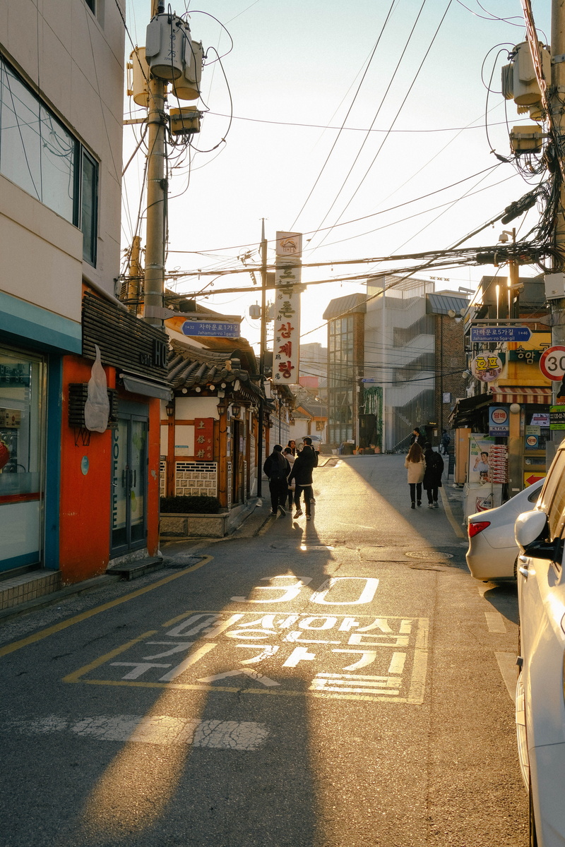 building, path, walkway, direction, car, diminishing perspective, sign, group of people, car wheel, south korea, street, vehicle, 5K, building exterior