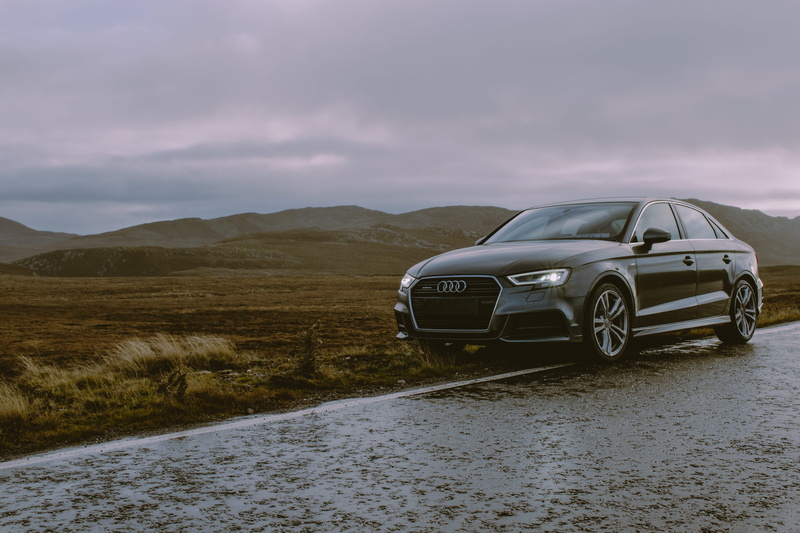 mode of transportation, cloud - sky, vehicle, non-urban scene, mountains, wheels, rain, road trip, motor vehicle, style, environment, front, headlights