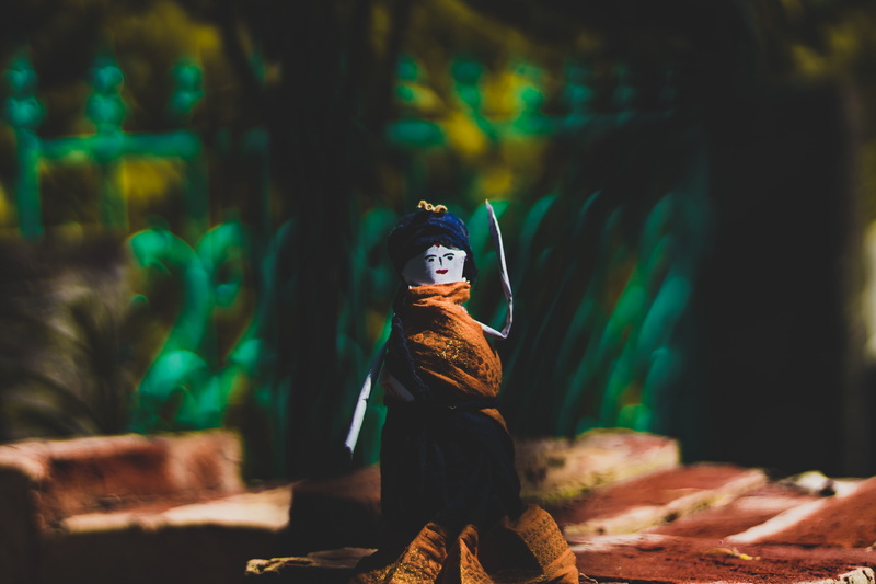 sitting, one person, art and craft, photography, representation, green color, man, hand made, paper, figurine, front view, 5K, toy, female likeness, artwork