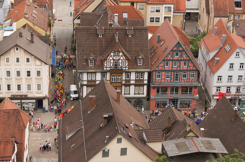 city life, crowd, house, homes, aerial view, mode of transportation, building, transportation, town festival, canal, city, town, view, group of people