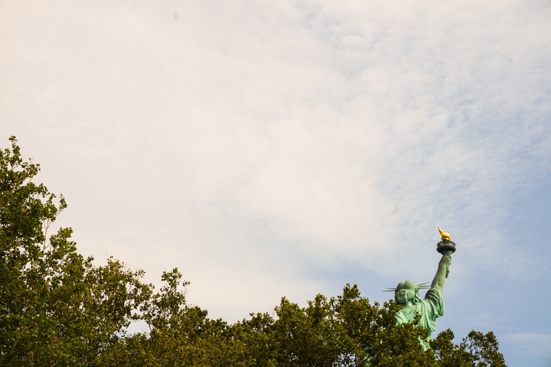 york, green color, creativity, green, city, human representation, low angle view, outside, sky, representation, new, tranquility, staten, out, nyc, island
