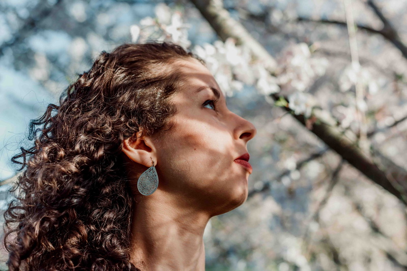 brown hair, lip, person, sideways, real people, light, springtime, tree, beautiful woman, day, one person, lifestyles, headshot, accessories, united states