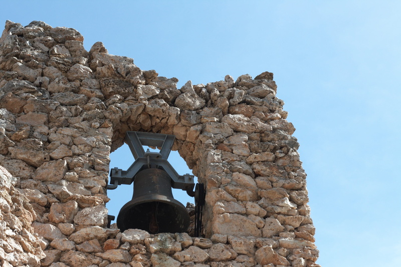 stone material, rock, stone wall, church, mijas, history, building exterior, built structure, sky, blue, historical, clear sky, outdoors, bell, wall, the past