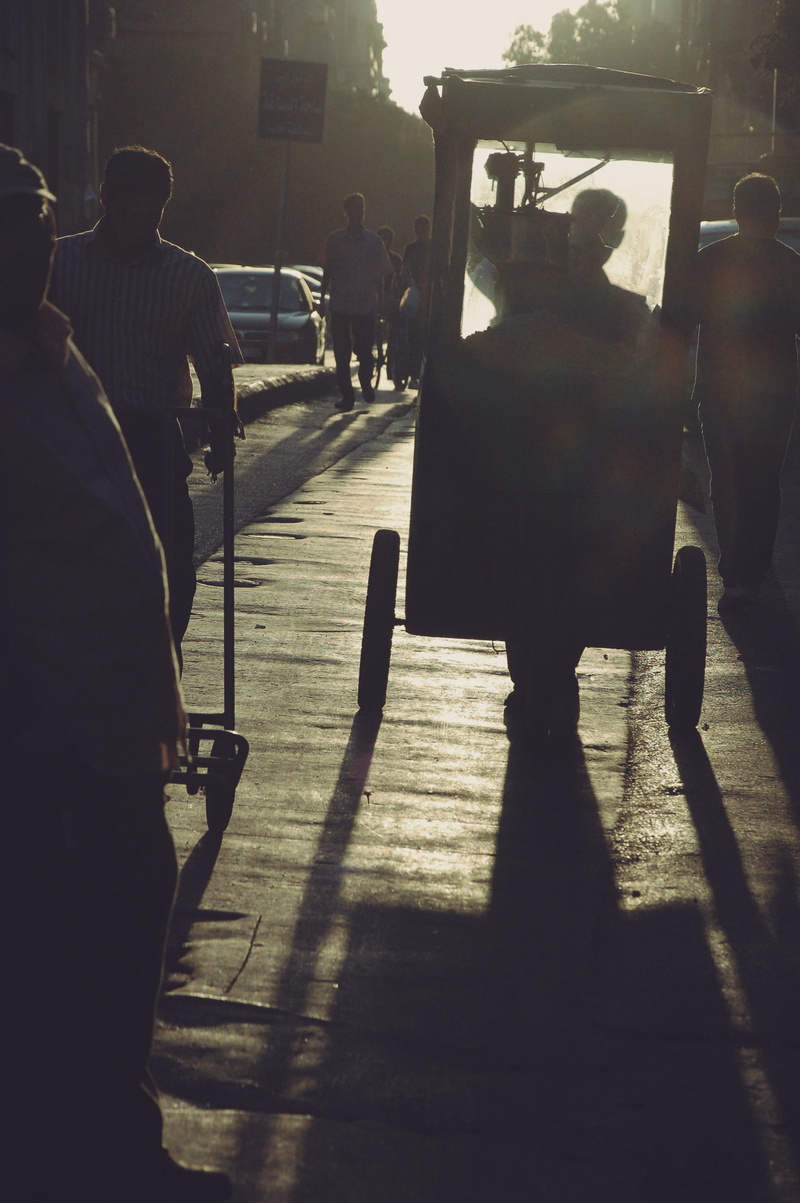 shadow, lifestyles, group of people, nature, rear view, outdoors, walk, wheels, sunlight, people, men, city life, transportation, scooter, incidental people