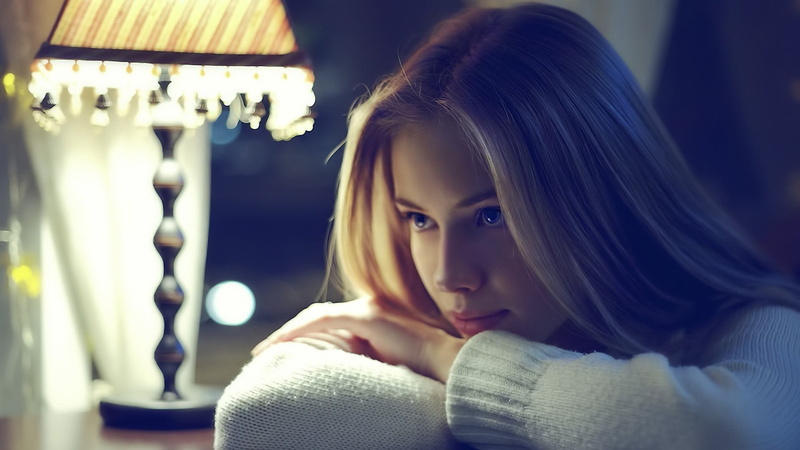 looking At Camera, desk, sensuality, comfortable, elegance, females, sleeved, real people, sitting, electric lamp, people, illuminated, white, woman, window