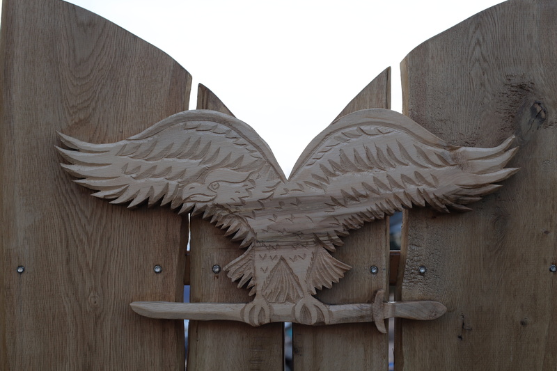 built structure, safety, fence, angel, wood, carving - craft product, sky, 5K, sas, day, coat of arms, turul bird, craft, wings, close-up, animal representation
