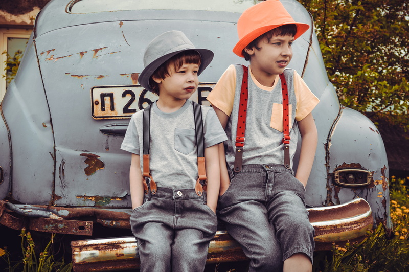 vehicle, outdoors, daylight, hat, togetherness, rusty, car, sibling, males, brother, siblings, men, bumper, leisure activity, children, street, wear, front view