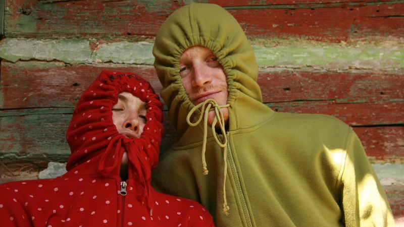 couple, real people, wall, front view, human Face, 1080P, brick, green, religion, faces, people, wall - building feature, warm clothing, men, hoodie, leisure activity