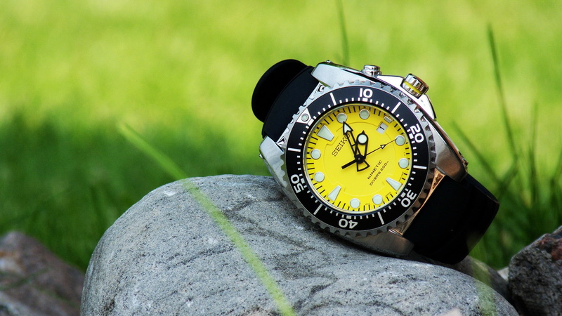 outdoors, clock, rock, green color, clocks, rock - object, instrument of time, time, Seiko, nature, solid, accuracy, clock face, grass, number, day, minute hand