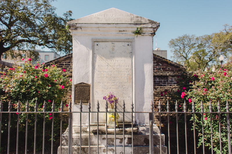 outdoors, crypt, no people, railing, flagstone, flower, sculpture, slate, history, flower bouquet, day, human representation, monument, archaeology, flowering plant