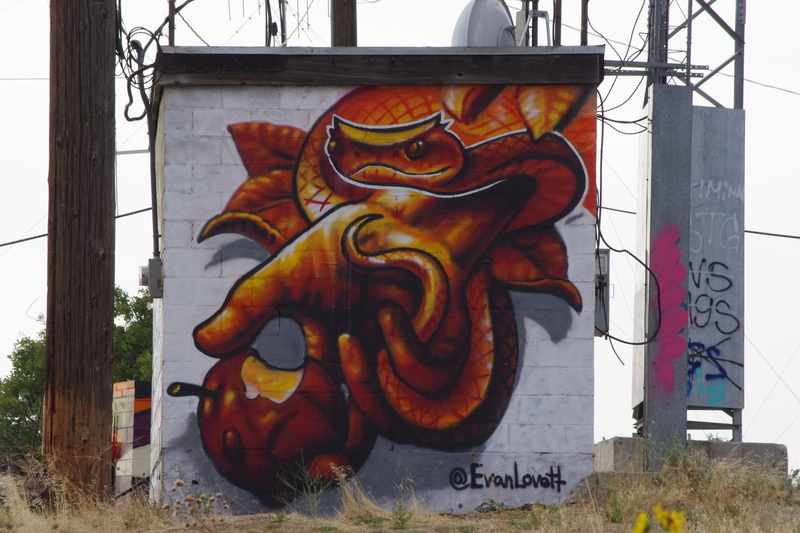 temptation, snake, human representation, communication, text, eden, representation, craft, day, plant, built structure, outdoors, graffiti, apple, architecture