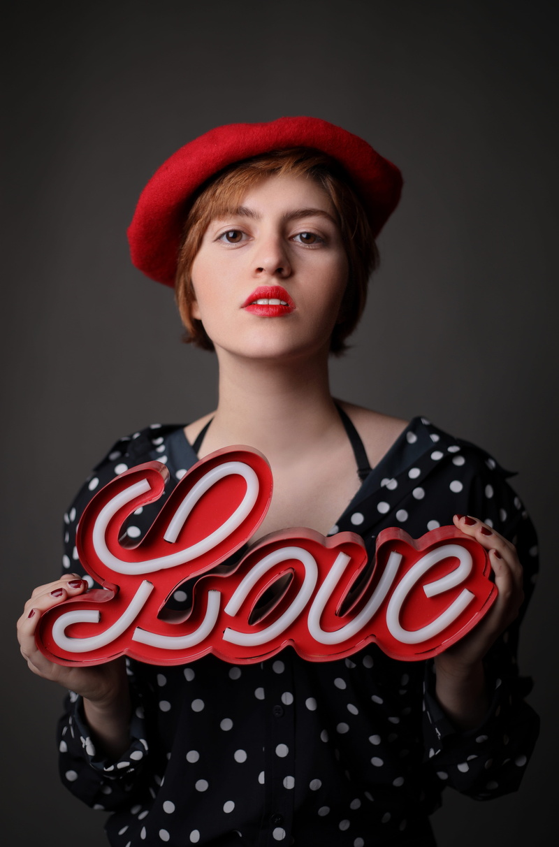 wearing, studio shot, women, dot, one person, beautiful woman, clothing, white, young women, indoors, red, holding, black, black background, teenager, letter