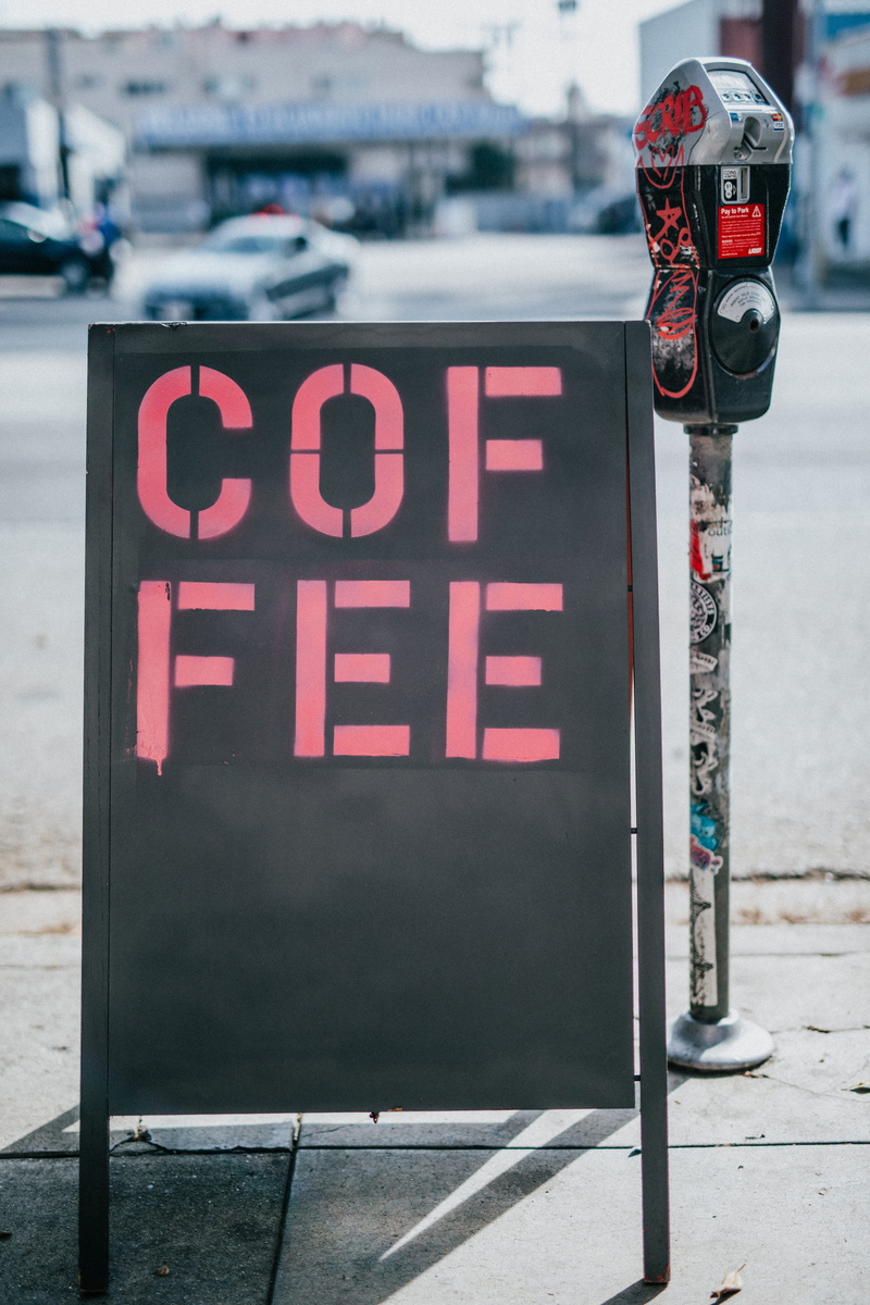black, standee, biometrix, post, text, outdoors, slot, western script, coffee shop, road, cafe, capital letter, safety, coin, street, built structure, freestanding