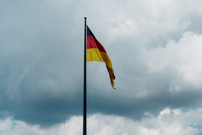 patriotism, yellow, berlin, pole, deutsche flagge, national, low angle view, waving, germany, emotion, deutschland, outdoors, german flag, dark clouds