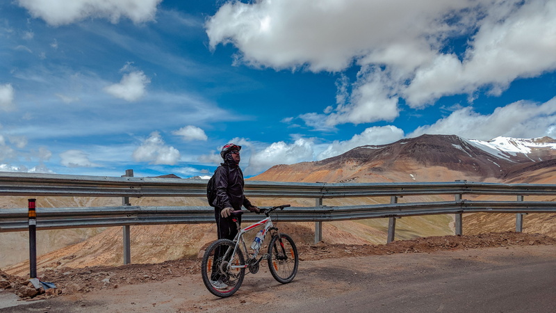 bird, path, looking at view, machine, cloud - sky, himalaya, cloud, one person, human, full length, bike, adult, sports, vehicle, look, riding, mountain