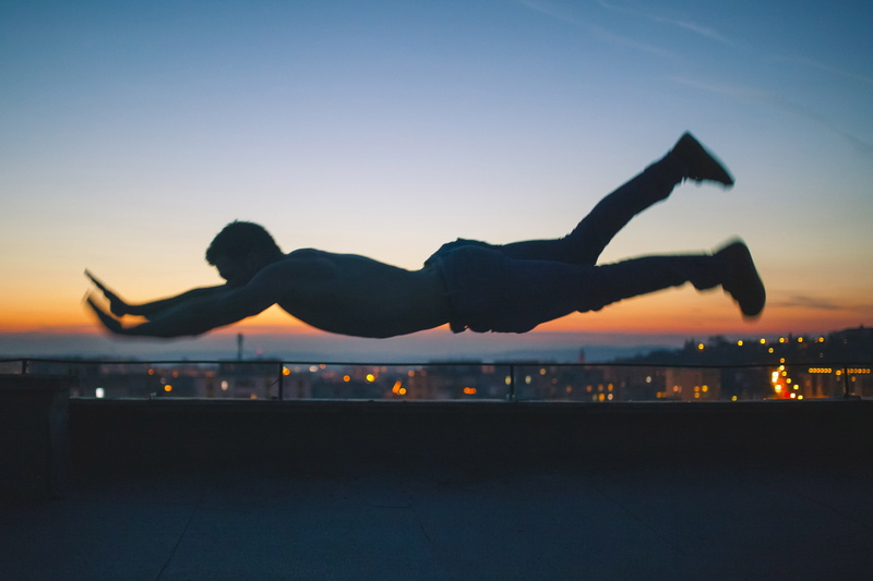 in the air, golden, human arm, cityscape, top, nature, back Lit, planking, dusk, leisure activity, lifestyles, sky, man, gray, airplane, healthy lifestyle