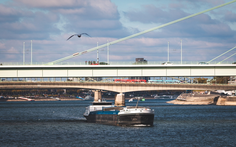built structure, building exterior, city, waterfront, arch bridge, nautical vessel, cloud - sky, architecture, nature, transportation, outdoors, connection