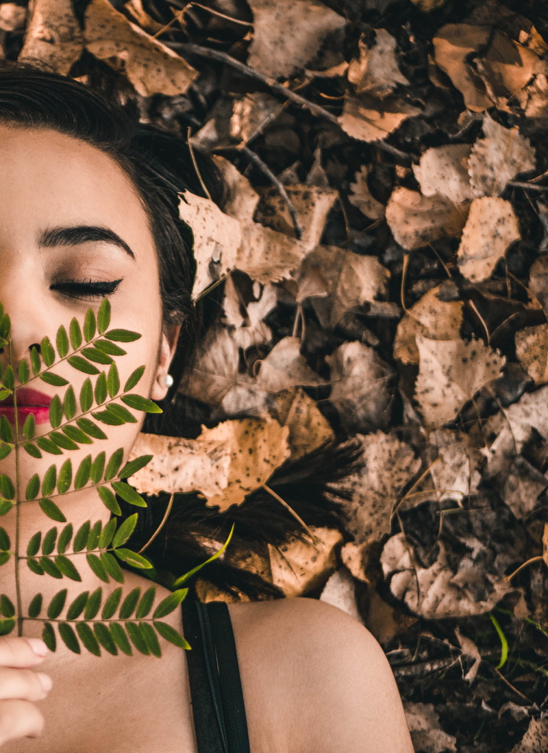 dead leaves, woman, holding, headshot, makeup, hairstyle, adult, green, plant part, forest, leaf, nature, outdoors, leisure activity, portrait, human body part